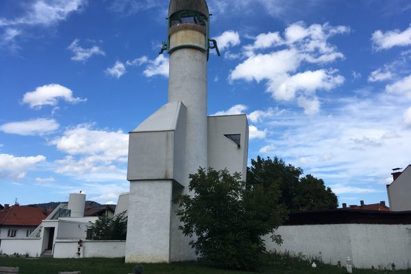 The unusual green pipes on the roof set the building apart.