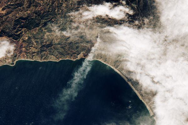 A satellite image shows smoke from the Palisades Fire spreading across Los Angeles and out into the Pacific Ocean on January 7, 2025.
