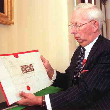 Charles Goodwyn, Keeper of the Royal Philatelic Collection, with copies of world&#8217;s first stamp