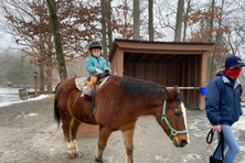A child being led on a horse at Rocking Horse Ranch