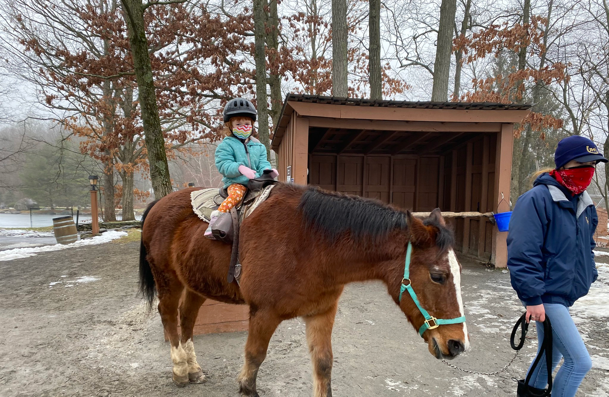 A child being led on a horse at Rocking Horse Ranch